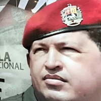 Mural in the streets of Caracas with a photo of Commander Hugo Chavez next to a caption that reads Dia de la Dignidad Nacional (National Dignity Day), and a photo of Chavez while he was in prison. Photo: ONCOP/file photo.